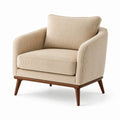 Sillón de pana beige con patas de madera